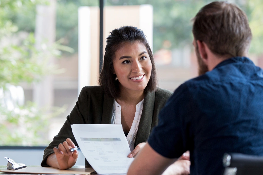 A friendly solicitor from Gildeas Solicitors in Edinburgh discusses a personal injury claim with a client, explaining mitigation strategies to support their case in Scotland.