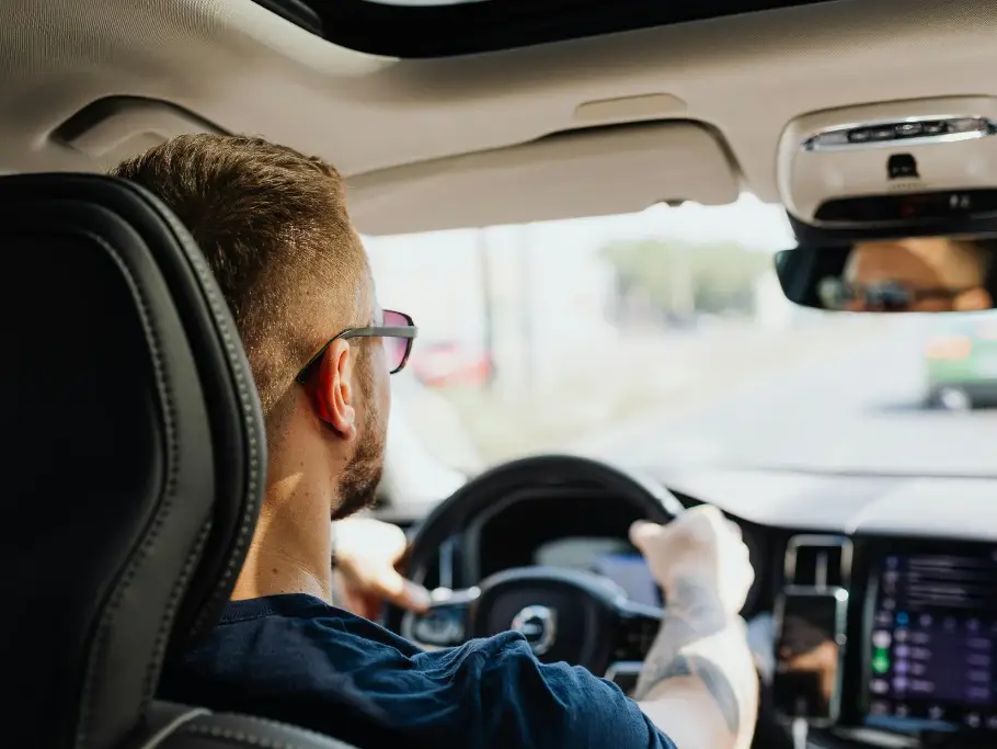 Driver involved in a road traffic accident in Scotland holding steering wheel, relevant to personal injury compensation claims and impecuniosity.