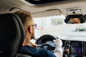 Man driving a car after a personal injury claim with guidance from Gildeas Solicitors.