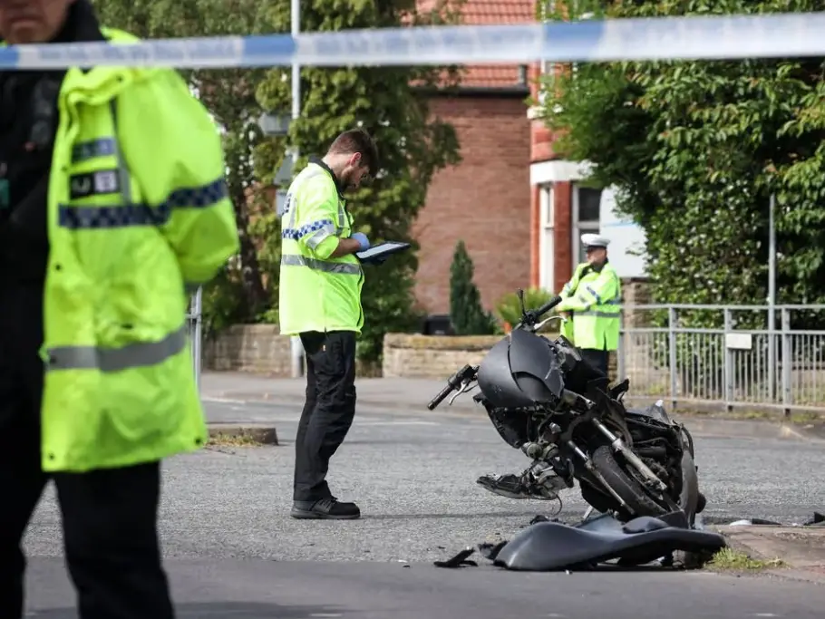 Police officers investigate a motorbike accident on a residential road, with a damaged motorbike and debris visible at the roadside. Gildeas Solicitors supports injured motorcyclists following serious road accidents.